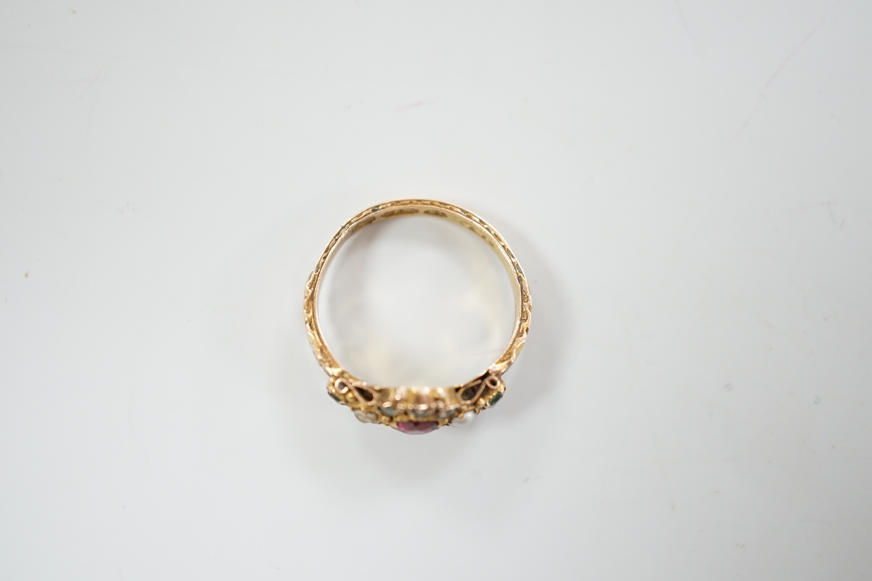A late Victorian 15ct gold, ruby?, emerald and seed pearl cluster set dress ring, size K, gross weight 2.6 grams, with engraved shank.